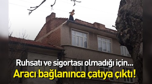 Eskişehir'de bir vatandaş araç bağlanınca çatıya çıktı!